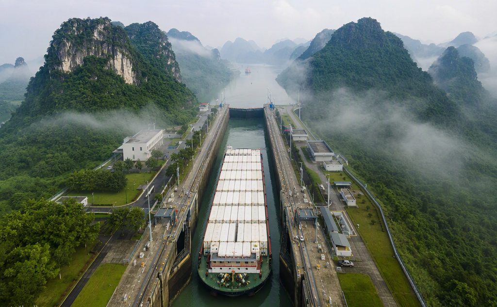 A river-sea barge transiting the canal with reefer containers